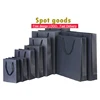 Wholesale spot goods custom luxury clothes bag black shopping paper bag kraft gift packaging bag with logo print
