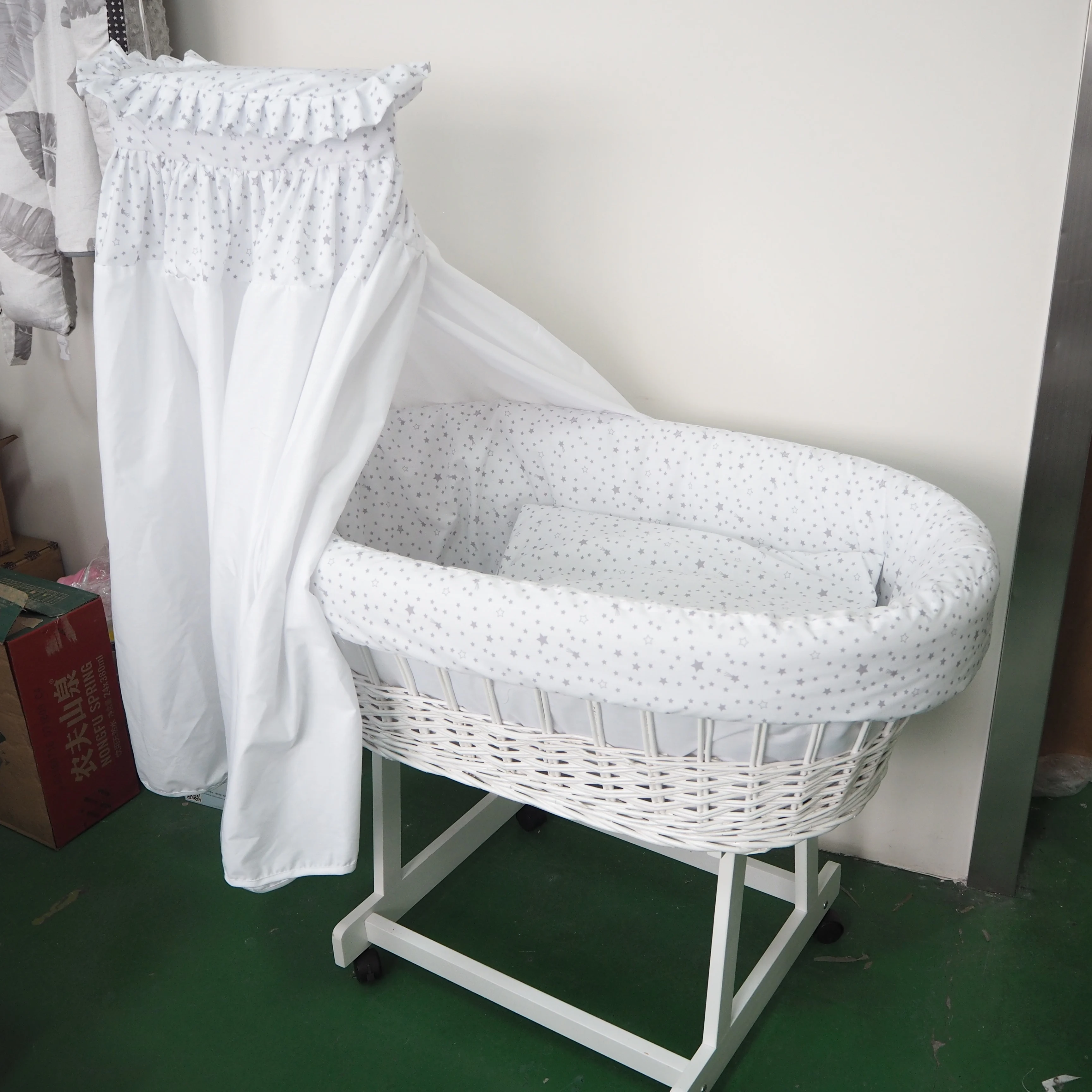 white moses basket with drapes