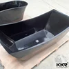 Solid stone glossy floor standing black bath tub