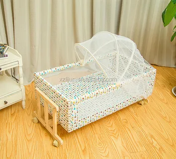 wooden cradle with mosquito net