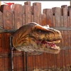 Hanging on the wall spraying smoking mechanical T-Rex head
