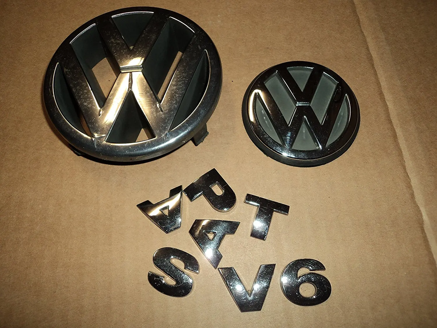 vw passat front emblem replacement