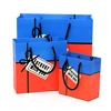 Modern design luxury gift packaging bag with flowers wholesale custom fancy fashion designer handle gift paper bag