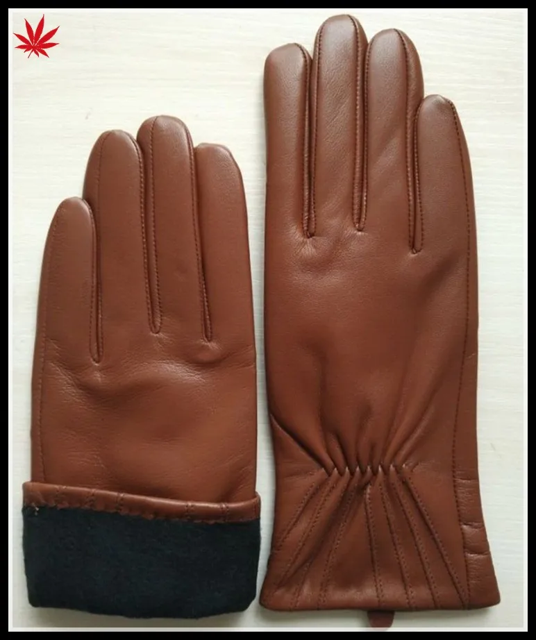brown genuine leather hand gloves women putting on leather glove
