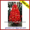 big outdoor decorated artificial lighted plastic fake christmas tree with poinsettia flower