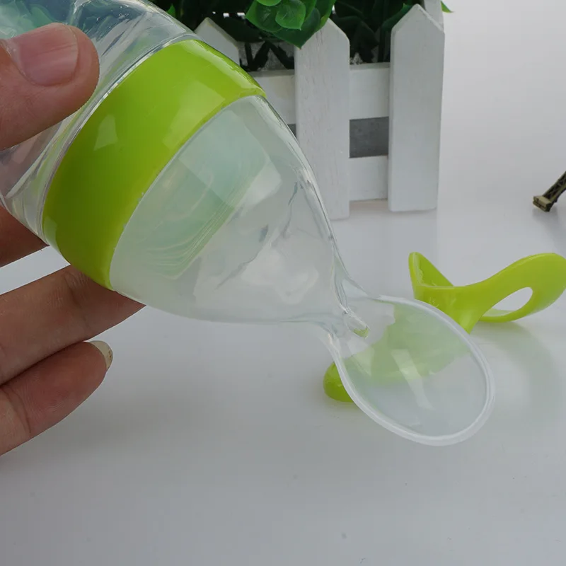 baby feeding bottle with spoon attached