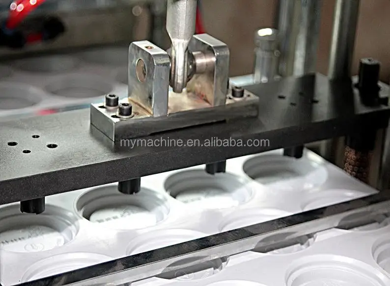 Plastic lid machine Punching hole part.JPG