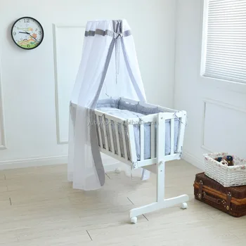 white wooden cradle