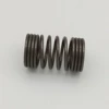 Adjustable compression tractor seat coil spring