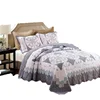 patchwork style printed bedspread with quilting in patchwork pattern