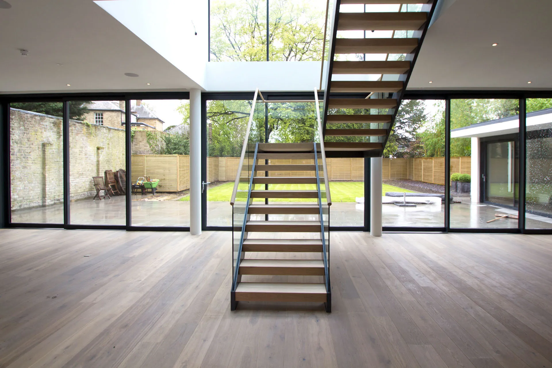 modern wood stair treads staircase with floating glass panel
