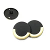 Metallic button with gold curved strip on round black bottom and high button for garment