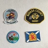 Irregular shape woven embroidery emblem