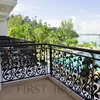 Decorative wrought iron veranda railings with scroll grill design