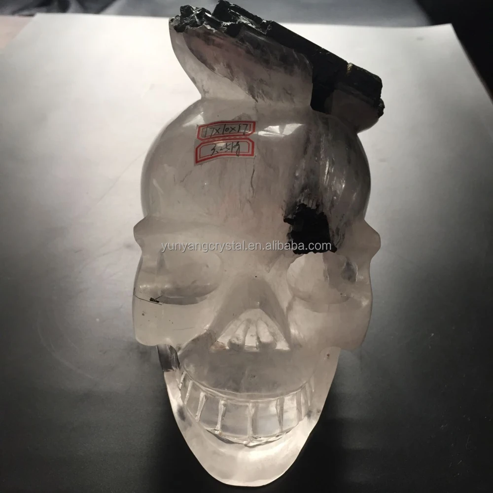 natural hand carved clear quartz crystal stone skull with black tourmaline
