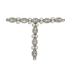 Silver chain links trim the rhinestone embellished T strap summer sandals