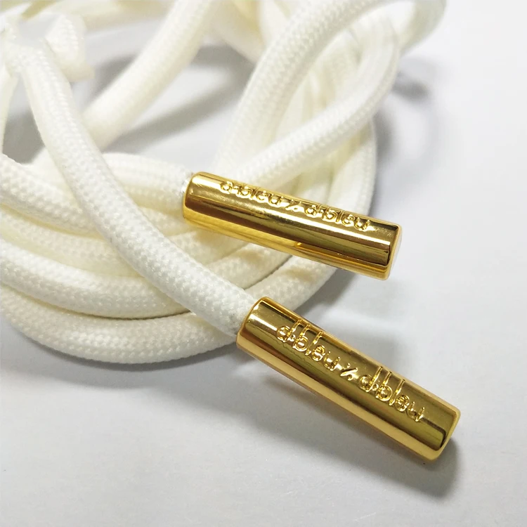 white flat laces with gold tips