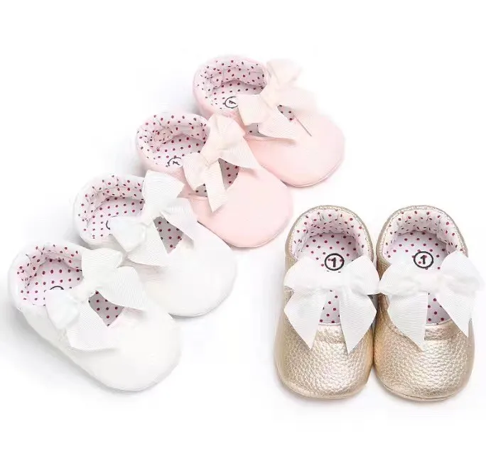 pink and gold baby shoes