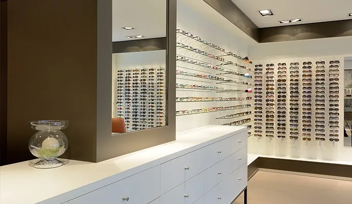 Branded eyewear retail shop wood display counter and glass shelving for sunglasses display