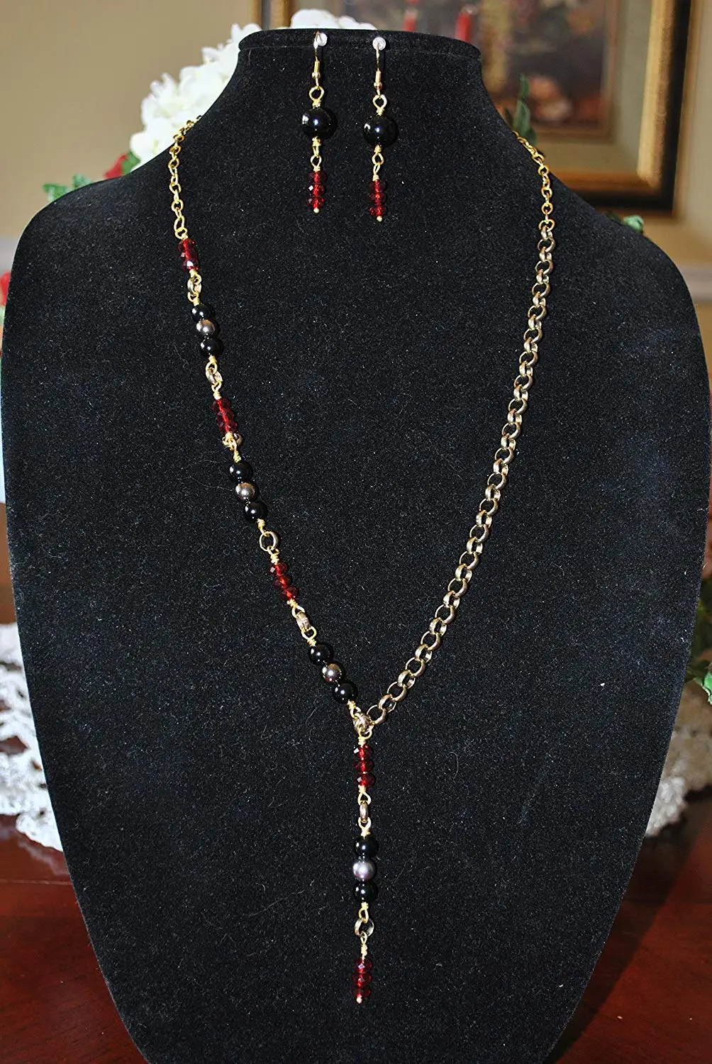 Beautiful gold-tone necklace with black and red beads with matching earrings. Necklace measures 13 1/2" Earrings measure 1 1/2"
