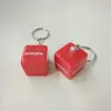 red acrylic cube keychain with white print logo