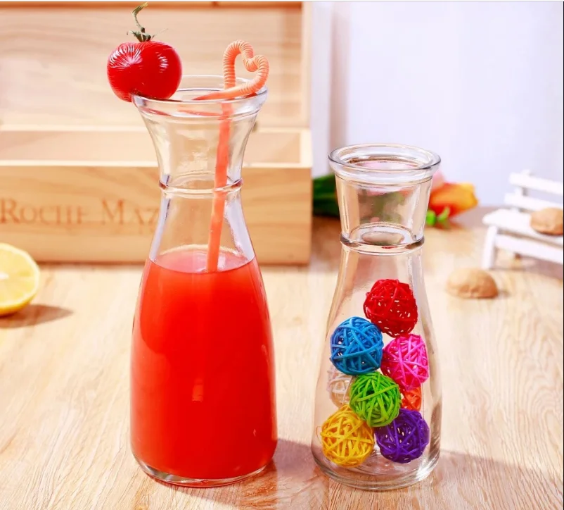clear glass juice beverage bottle with colorful straws