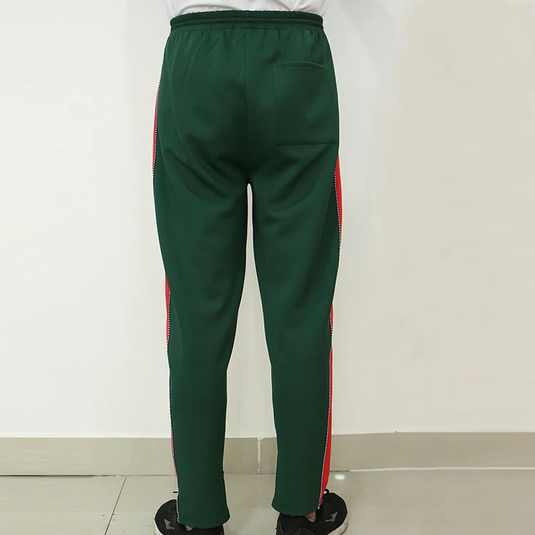 blue track pants with red stripe