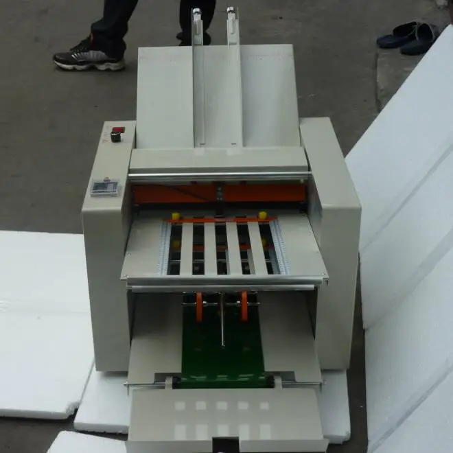 close up book folder machine factory