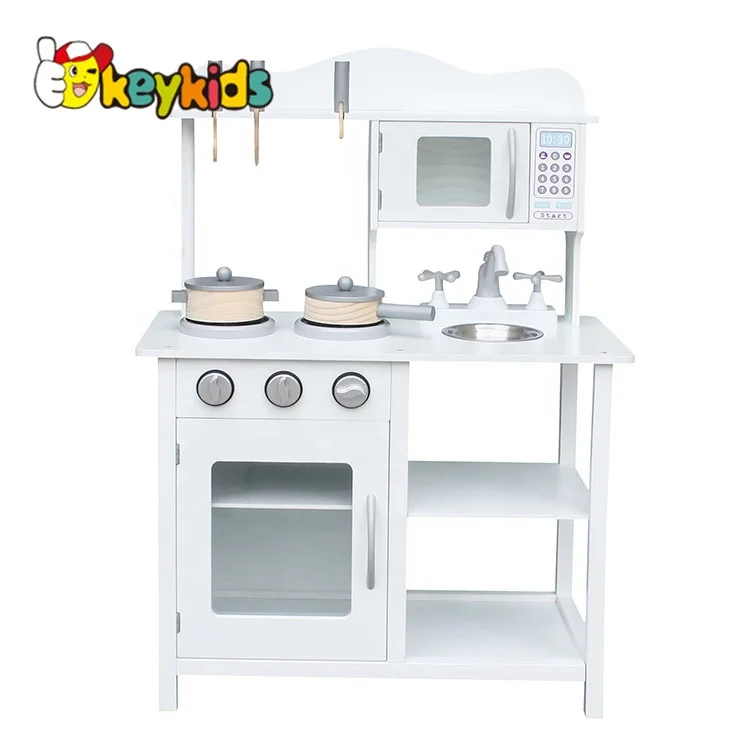 white wooden toy kitchen