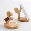 person shaped wooden mobile phone holder