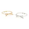 Silver bow charm bangle cuff