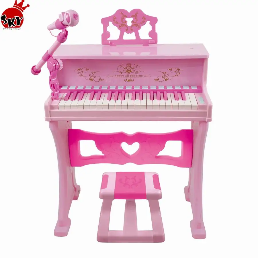 Antiguo mini piano musical en color rosa 
