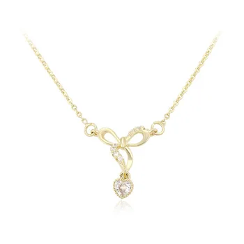 short gold necklace with charm