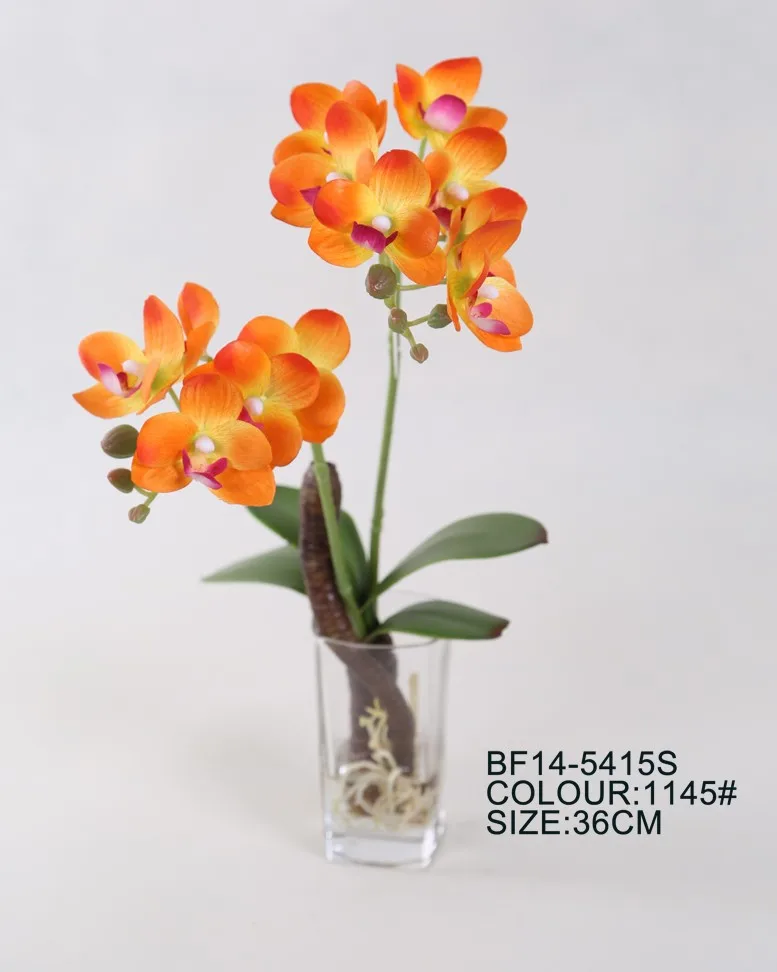 orange artificial flowers in vase