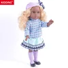 Beauty girl doll in a blue turtleneck sweater and purple bow hats Christmas present
