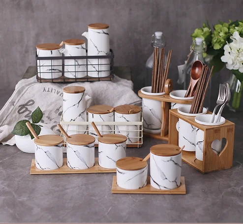 Cylindrical kitchenware marbling storage canisters / white ceramic canister with wood lid / spoon .png