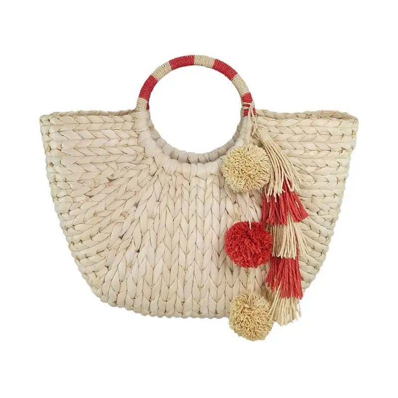 straw tote with pom poms