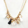 pearl and gold bead necklace shell with black white tassels