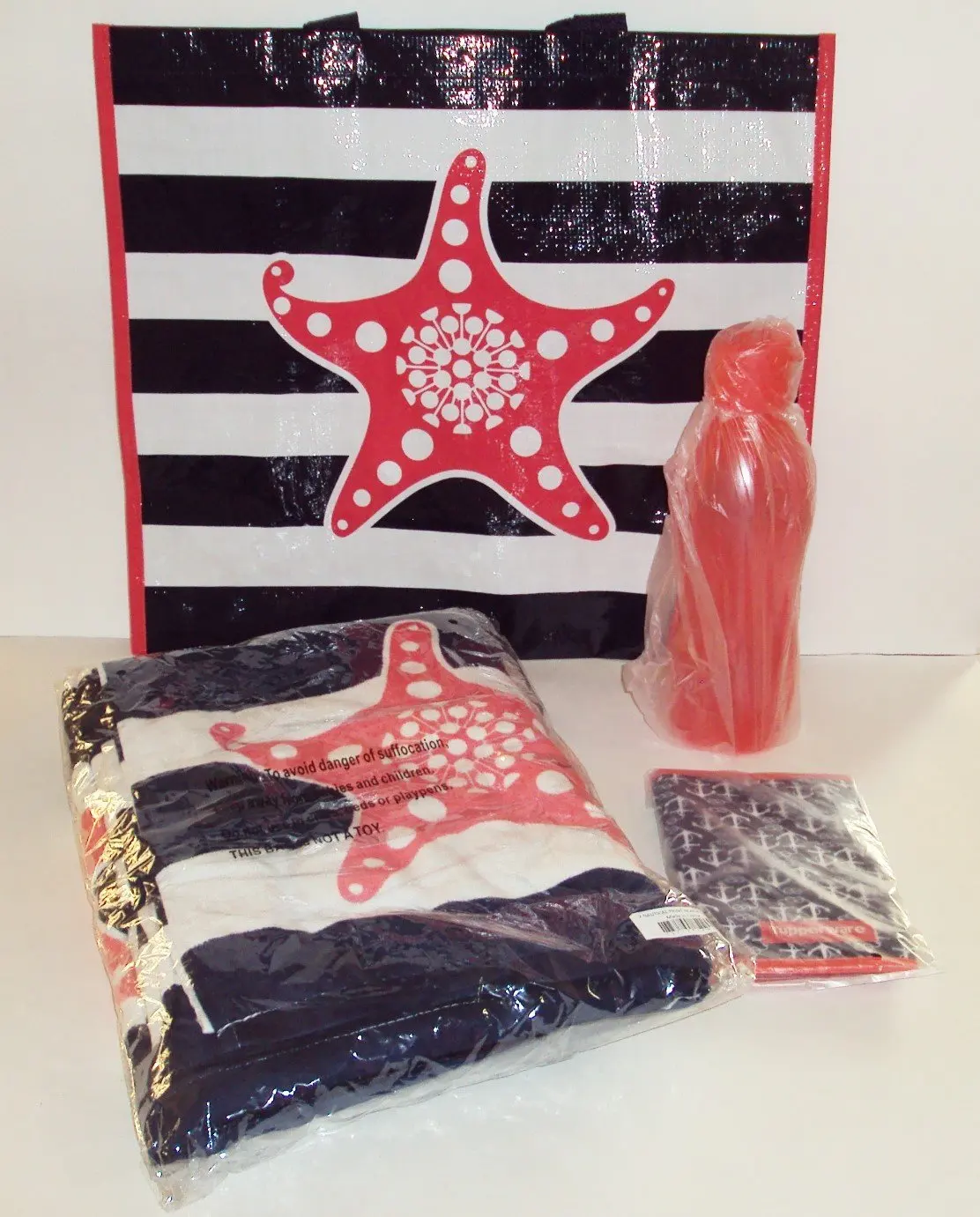 Tupperware New Seashore Beach Towel in Blue,White and Guava Colors.