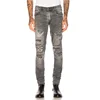 Men light gray patch cloth jeans slightly pulling whisker rib skin stitching overall damage fabric details pleating effect
