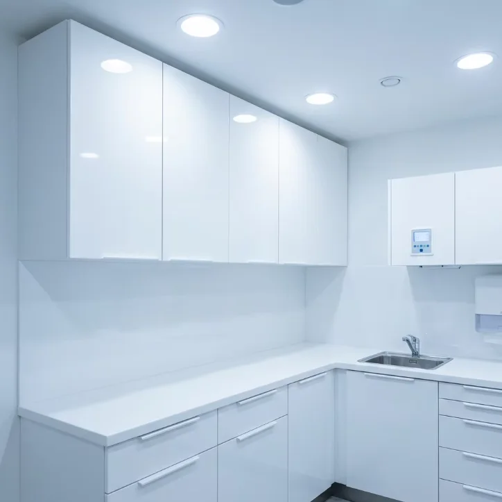 Clinical-grade dental and medical cabinetry with seamless surfaces and integrated sink for infection control.