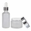 A set of frosted clear amber black personal skin care glass dropper bottles and glass jar