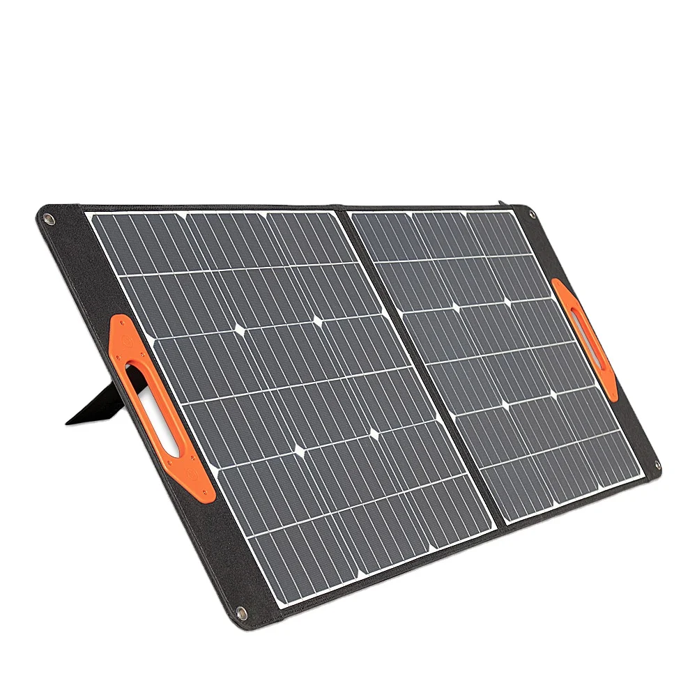 Foldable 100W portable solar panel unfolded on grass with adjustable stand and MC4/USB-C ports visible