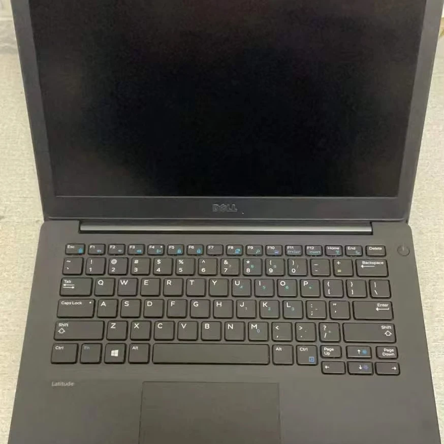 Close-up of 12-inch laptop showing 3K OLED display, thin bezels, and magnetic keyboard attachment