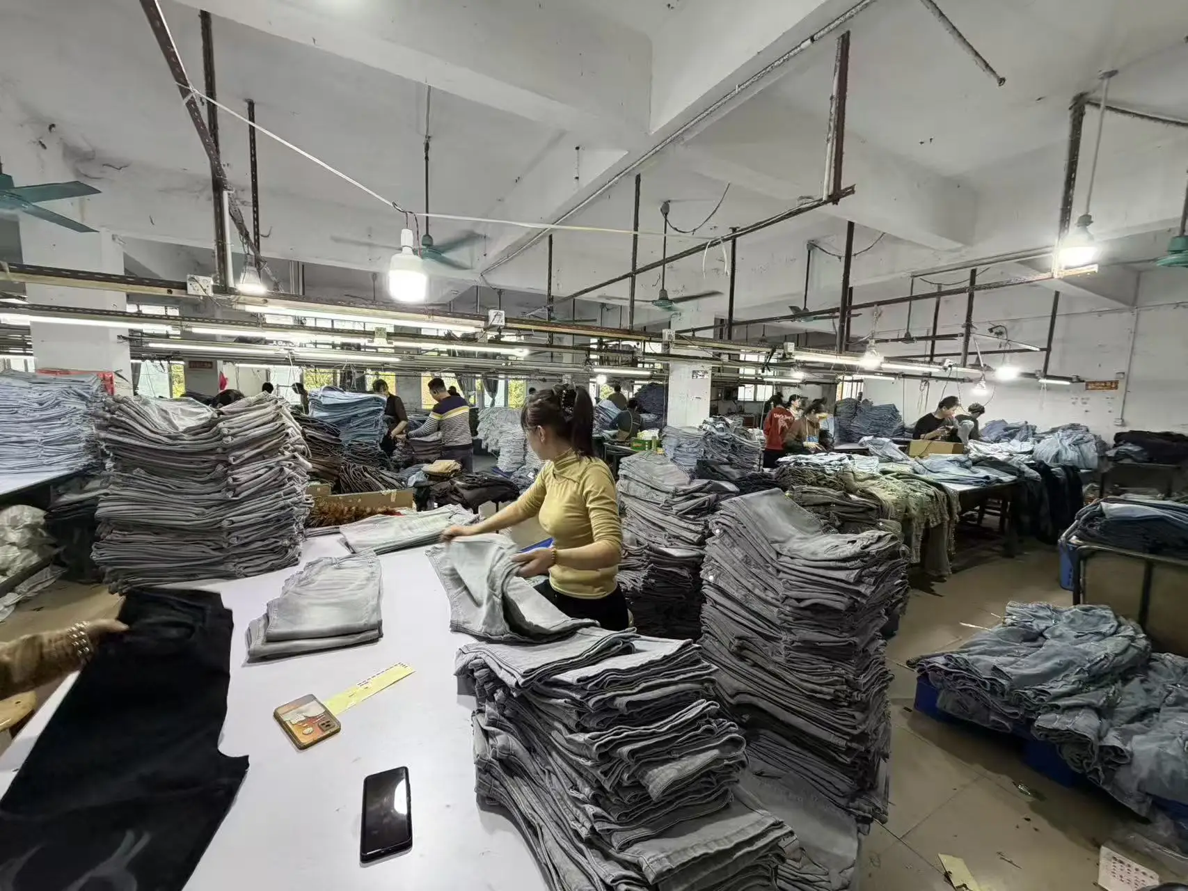 Quality control area in our Xintang factory, sorting and inspecting bulk denim orders.