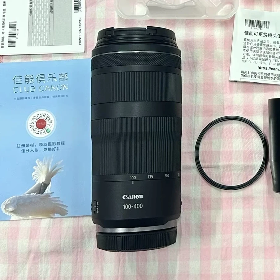 Canon RF 100-400mm lens mounted on EOS R6 Mark II, held comfortably by photographer in field