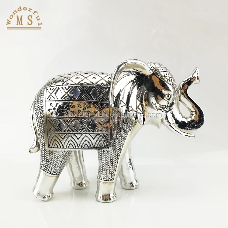 A shiny golden elephant statue dressed in ceremonial clothing symbolizes nobility glory and splendor Resin Craft for Homedecor