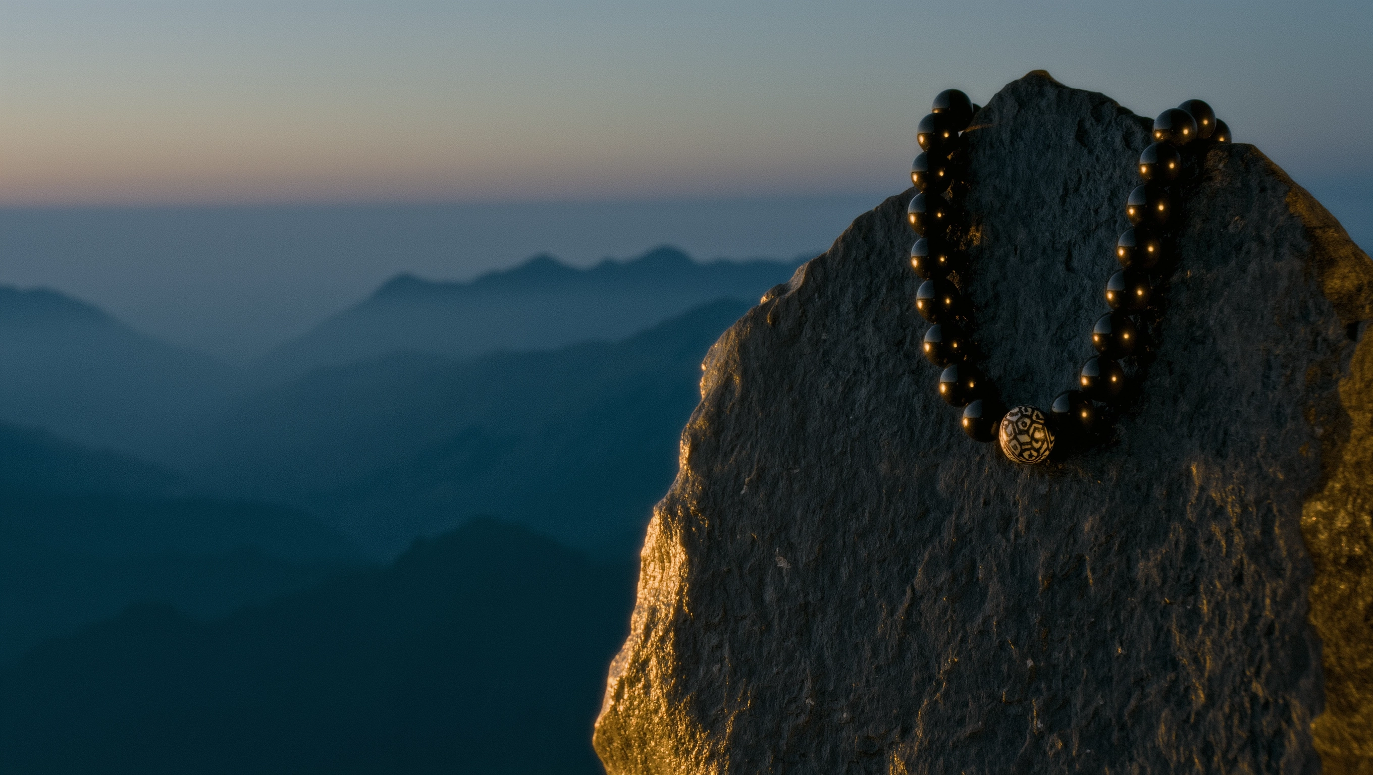 About Us 1 Sovereign Stillness Jewelry Origin: A divine manifest of mineral relics and obsidian beads on a mountain peak at dawn.