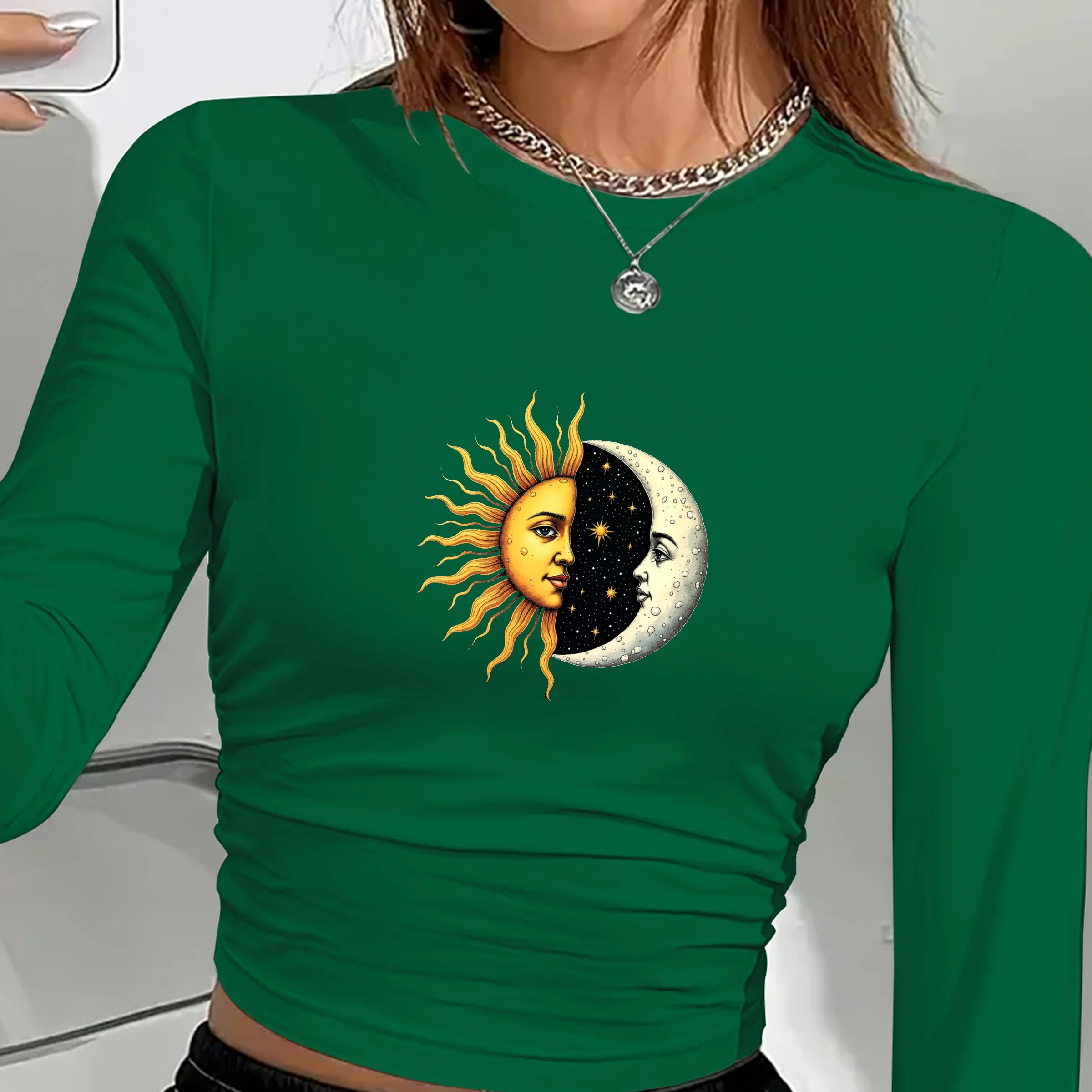 Women’s long sleeve shirt with artistic sun and moon faces print in a celestial boho design green