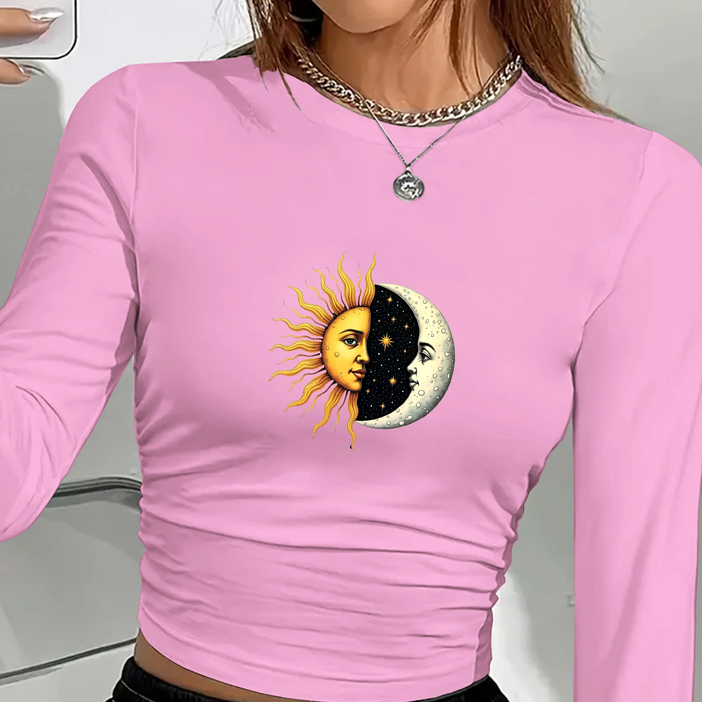 Women’s long sleeve shirt with artistic sun and moon faces print in a celestial boho design pink